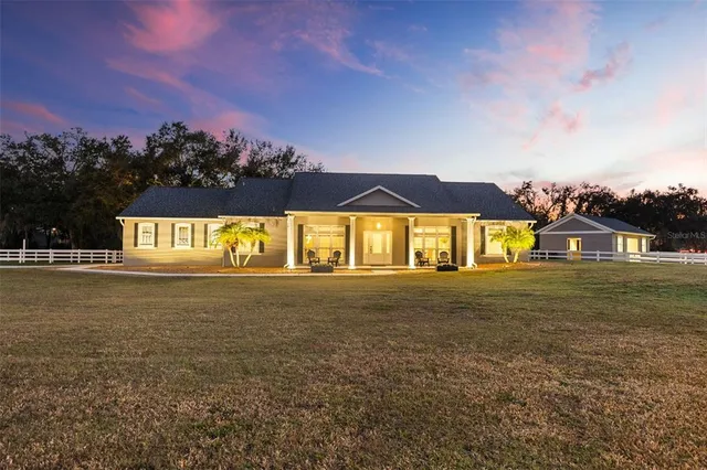 a front view of a house with a garden and yard