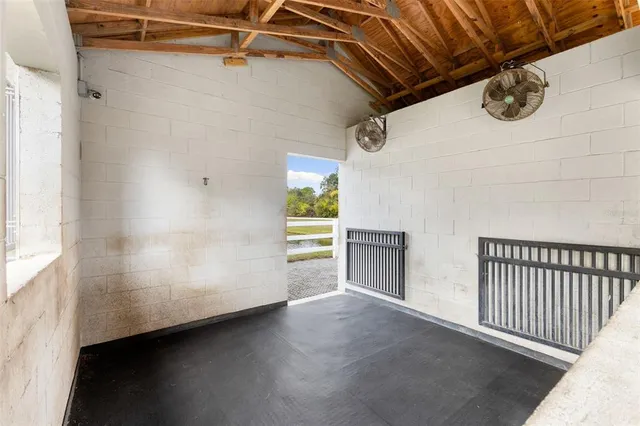 a view of a hallway with entryway and chandelier