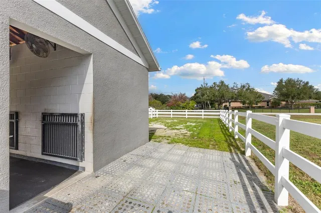 a front view of house with yard barbeque oven and covered with green space