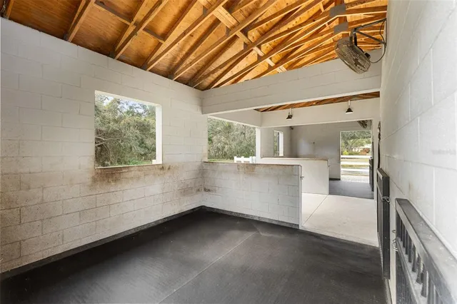 a view of a room with wooden floor