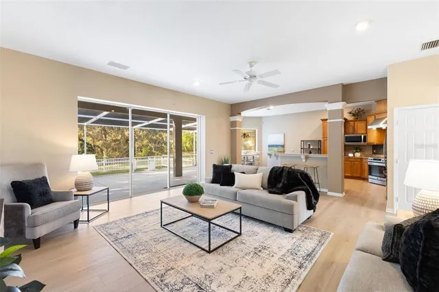 a kitchen with stainless steel appliances granite countertop a sink a stove and a wooden floors