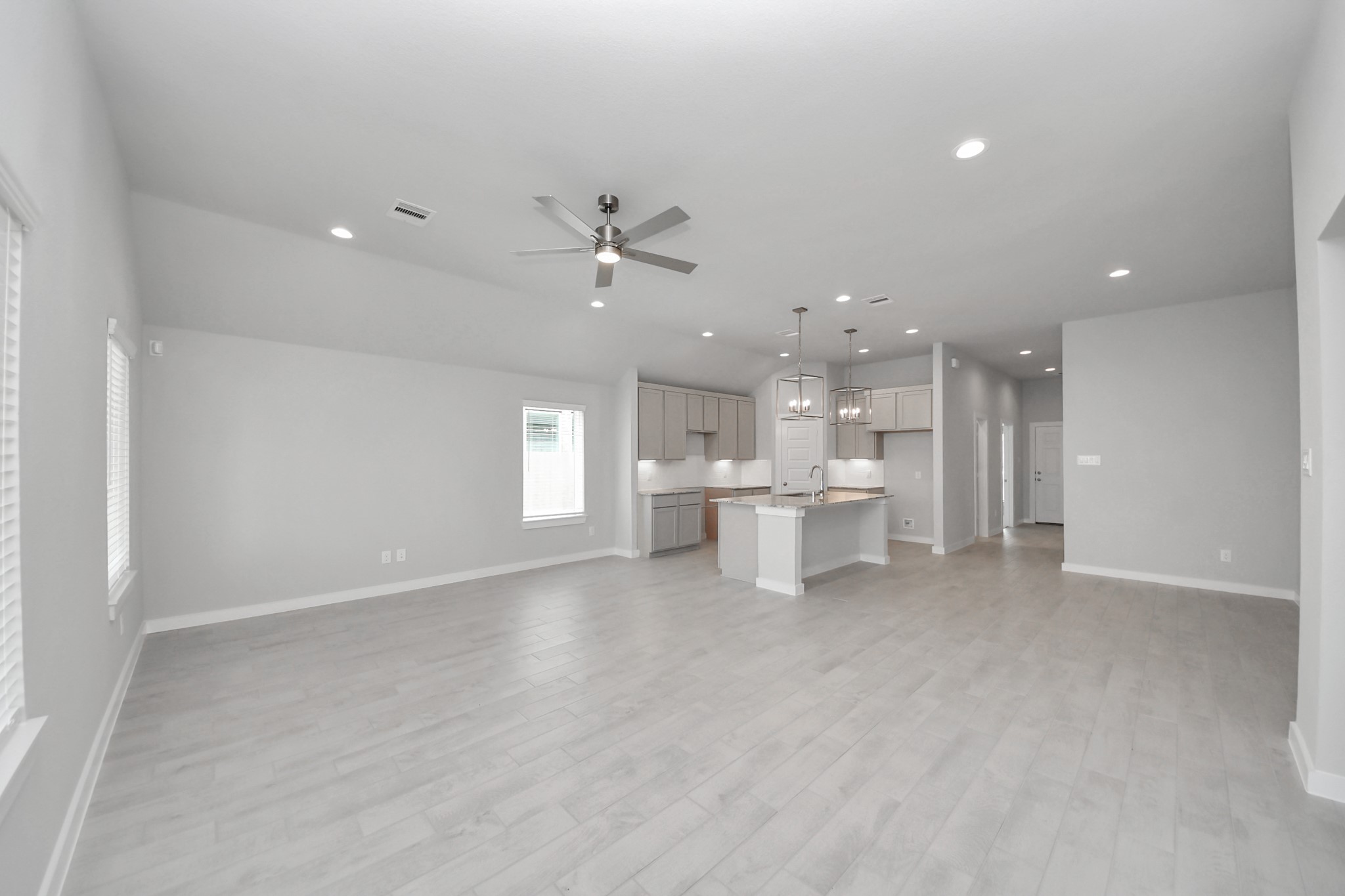 24518 Broad Park Spring, TX 77373 - Photo 18 of 29 Welcome family and guests to your charming living room! With its high ceilings, recessed lighting, ceiling fan, custom paint, beautiful flooring, and large windows that let in abundant natural light, this room is perfect for gatherings. Sample photo of completed home with similar floor plan. Actual colors and selections may vary.