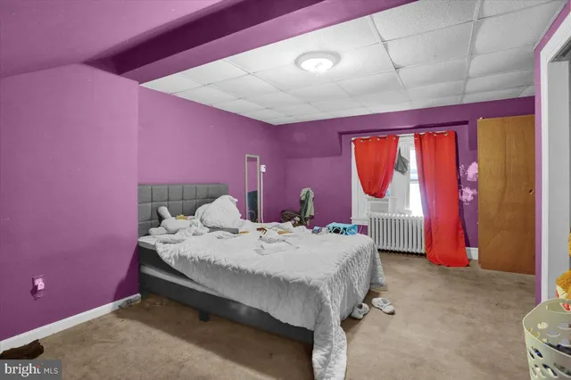 a bed room with a bed and a lamp