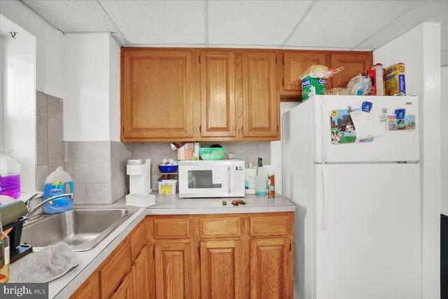 a white refrigerator freezer sitting inside of a kitchen