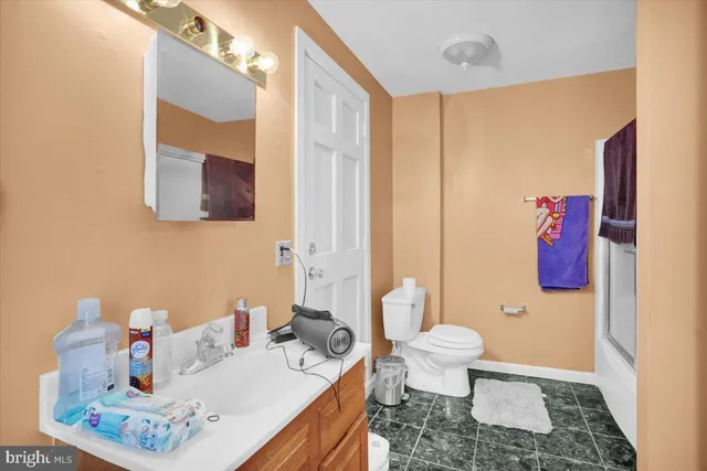 a kitchen with a refrigerator and a stove top oven