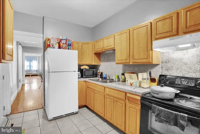 a kitchen with a refrigerator and a sink