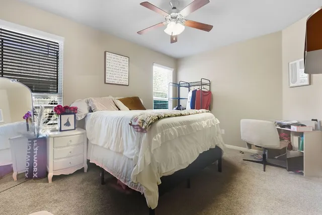 a bedroom with a bed and a chandelier