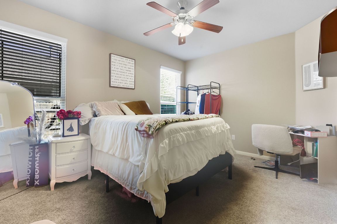 608 Palo Duro Loop Round Rock, TX 78664 - Photo 15 of 28 a bedroom with a bed and a chandelier