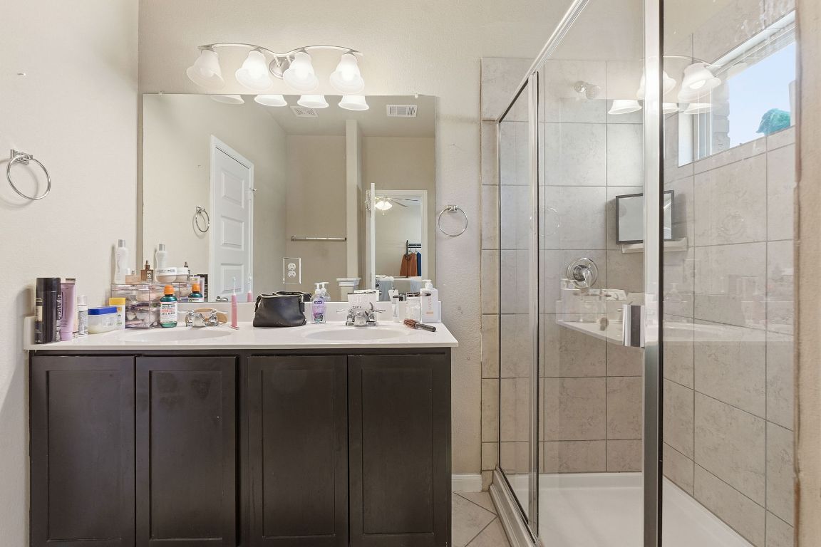608 Palo Duro Loop Round Rock, TX 78664 - Photo 16 of 28 a bathroom with double sink and a mirror