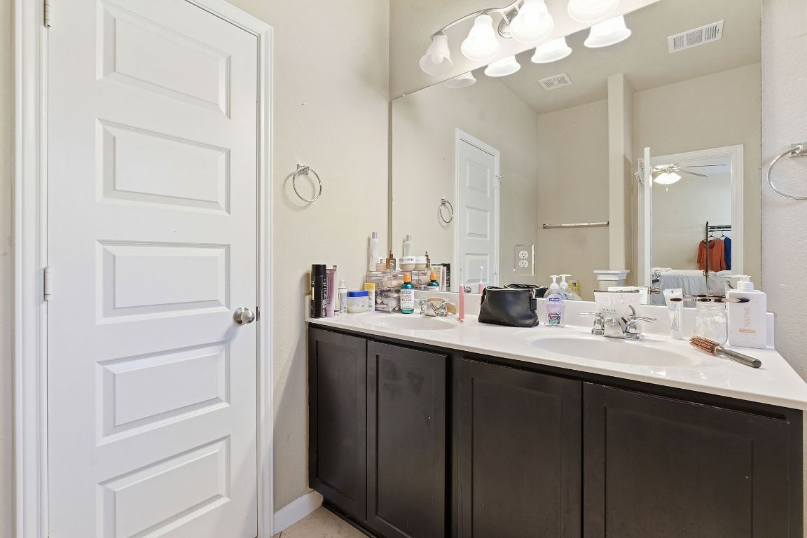 608 Palo Duro Loop Round Rock, TX 78664 - Photo 18 of 28 a bathroom with a double vanity sink and a mirror