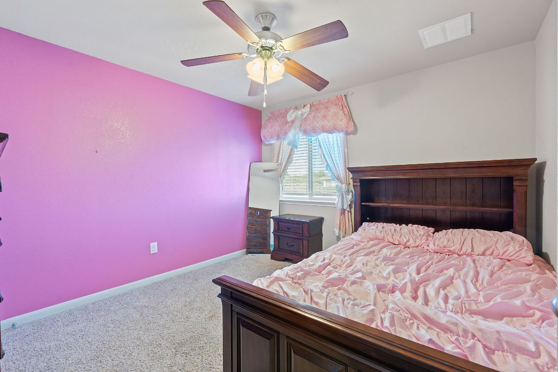608 Palo Duro Loop Round Rock, TX 78664 - Photo 19 of 28 a bed room with a bed and a chandelier