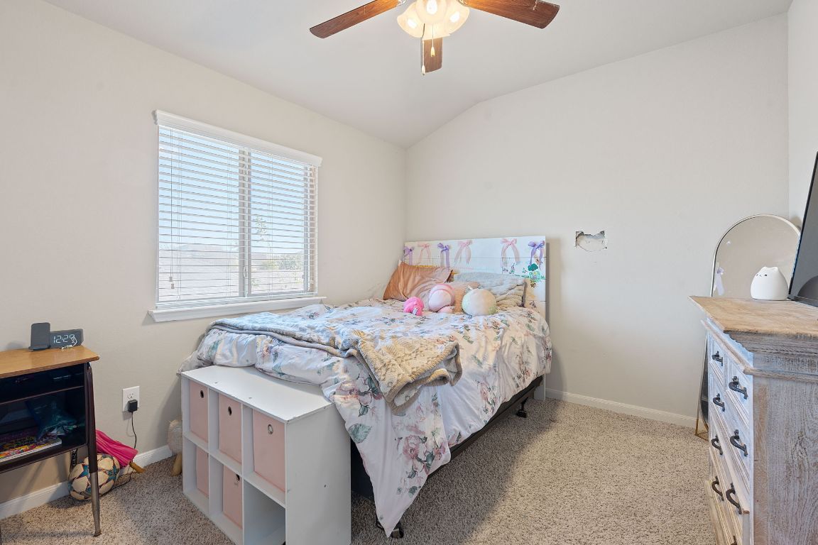 608 Palo Duro Loop Round Rock, TX 78664 - Photo 21 of 28 a bed sitting in a bedroom next to a window
