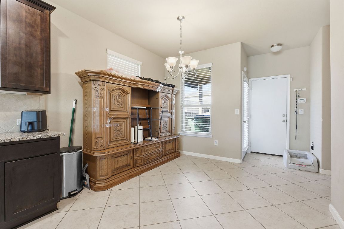 608 Palo Duro Loop Round Rock, TX 78664 - Photo 8 of 28 a kitchen with kitchen island granite countertop a refrigerator and a stove top oven