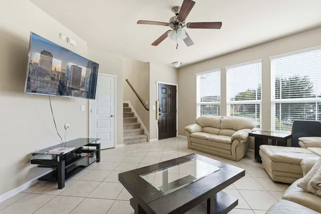 a living room with furniture and a flat screen tv