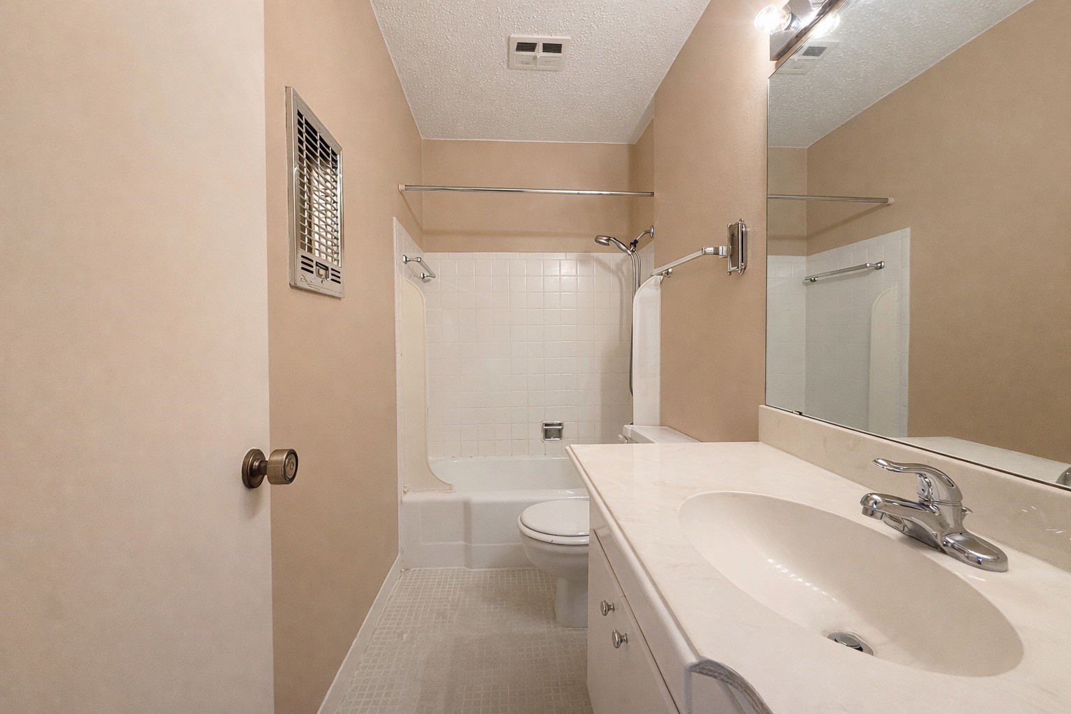 8223 Kingsbrook Road, Unit 215 Houston, TX 77024 - Photo 13 of 20 Primary bathroom with tub shower combo and vintage tile floors.