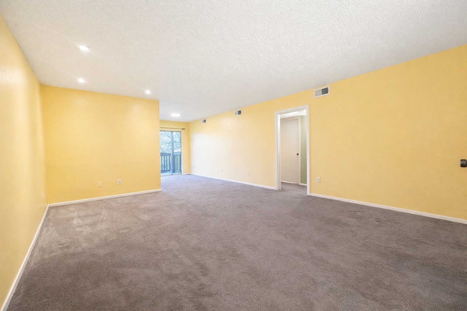 8223 Kingsbrook Road, Unit 215 Houston, TX 77024 - Photo 4 of 20 Living space with view of dining room and entry way to the hall leading to the two bedrooms.