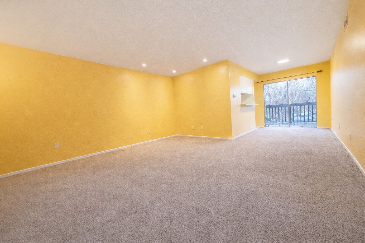8223 Kingsbrook Road, Unit 215 Houston, TX 77024 - Photo 5 of 20 Another angle showcasing the living area, offering views of the dining room and kitchen. The photo also features sliding glass doors that lead to a private balcony.