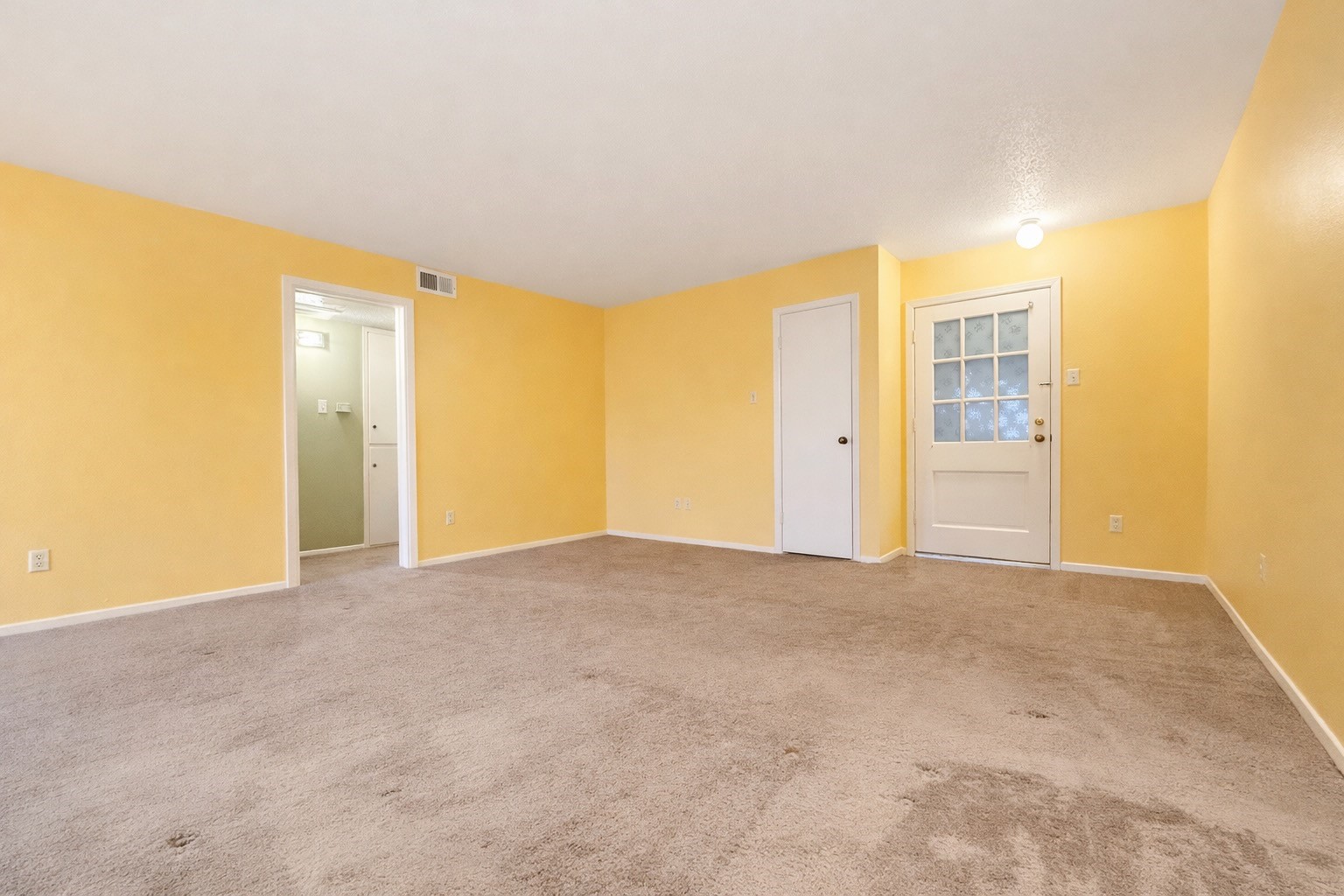 8223 Kingsbrook Road, Unit 215 Houston, TX 77024 - Photo 6 of 20 Another angle showcasing the living area and the front entrance. The laundry closet contains a stackable washer and dryer.