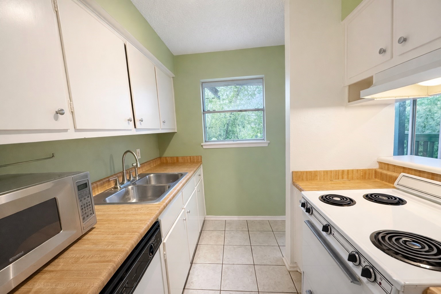 8223 Kingsbrook Road, Unit 215 Houston, TX 77024 - Photo 10 of 20 Another angle of the kitchen showcasing the window and the abundance of natural light streaming in.