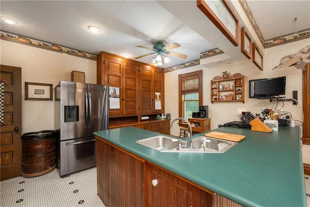 a kitchen with stainless steel appliances granite countertop a sink a stove and a refrigerator