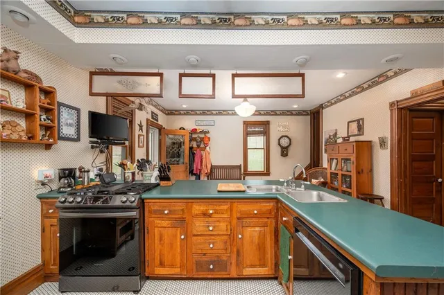 a kitchen with stainless steel appliances granite countertop a sink and cabinets
