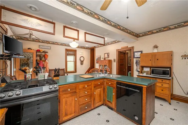 a kitchen with a sink stove and cabinets