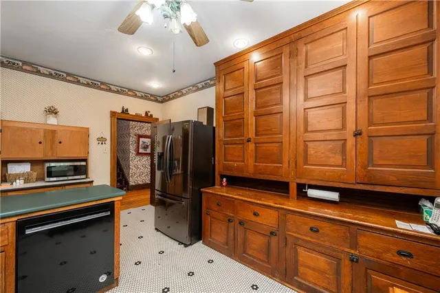 a kitchen with stainless steel appliances granite countertop a refrigerator and cabinets