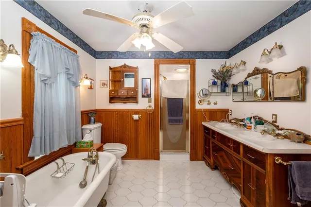 a bathroom with a sink a chandelier and a bathtub