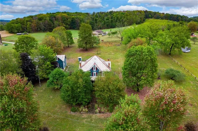 an aerial view of residential houses with outdoor space and street view