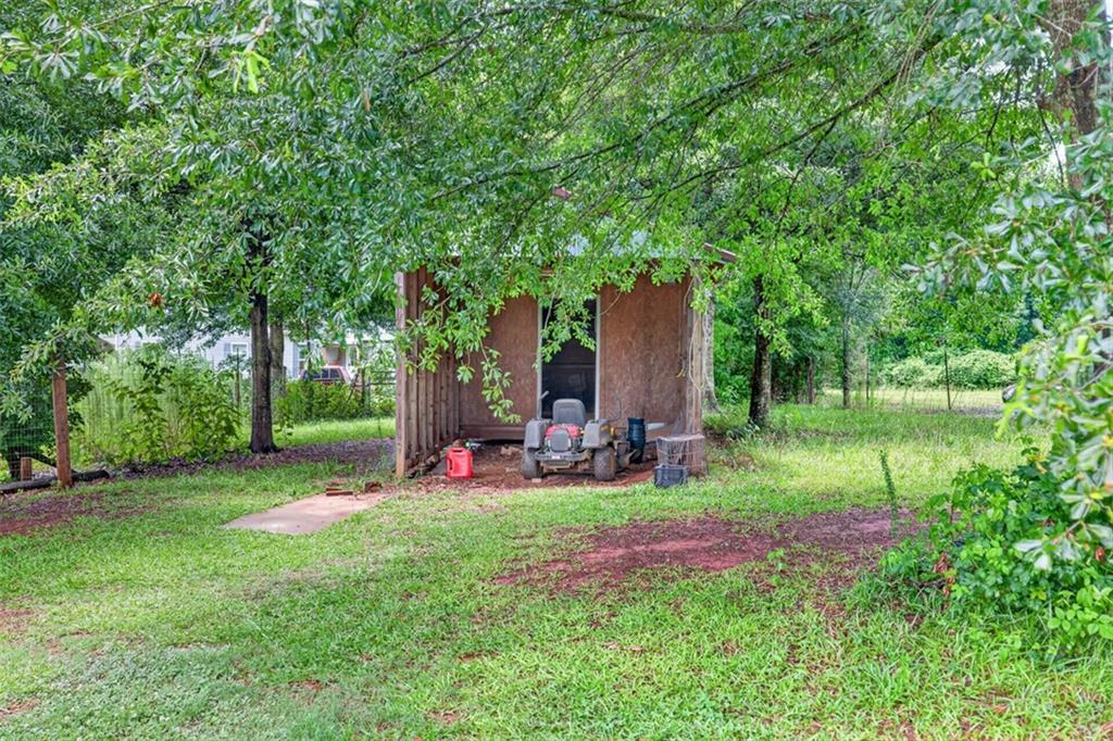 602 Pendergrass Road Winder, GA 30680 - Photo 37 of 44 a view of a backyard with table and chairs and a large tree