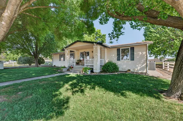 a front view of a house with yard and green space