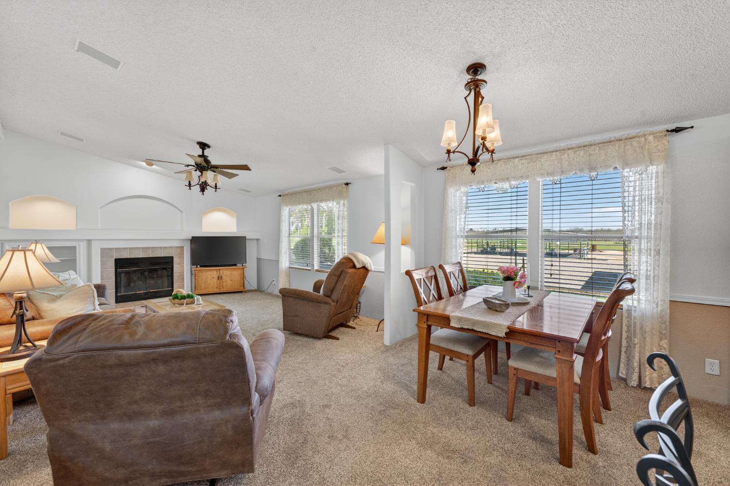 2450 George Road Williams, CA 95987 - Photo 18 of 43 a living room with furniture a fireplace and a chandelier