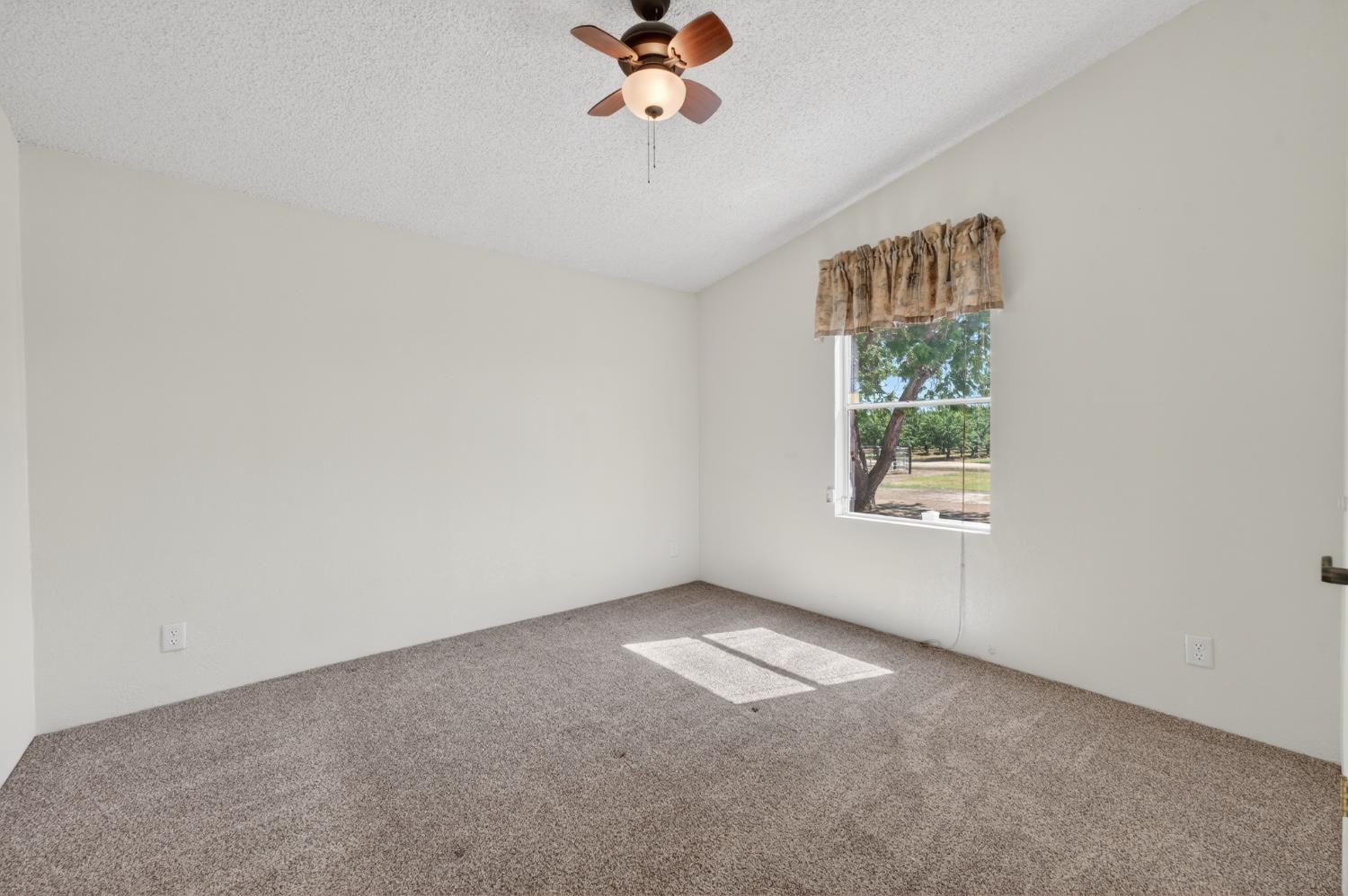 2450 George Road Williams, CA 95987 - Photo 32 of 43 an empty room with windows and chandelier fan