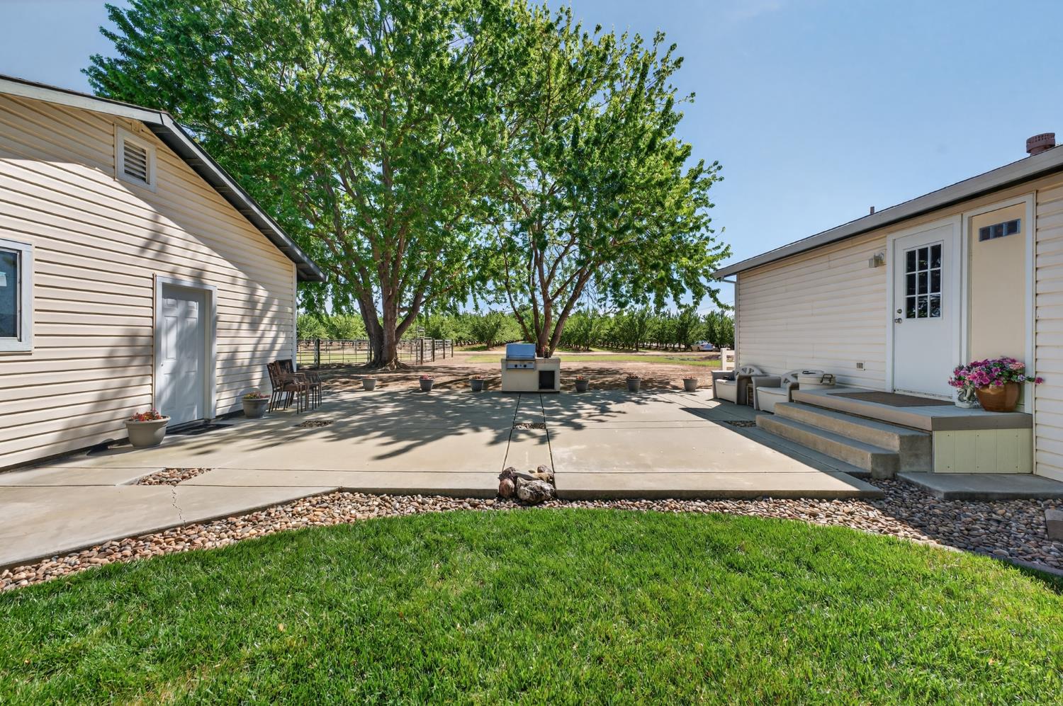 2450 George Road Williams, CA 95987 - Photo 35 of 43 a view of a backyard with a table and chairs and potted plants