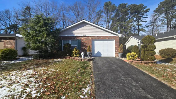 a view of a house with a yard and garage