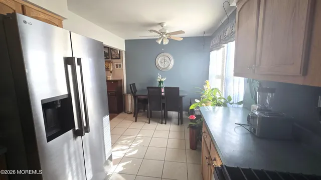 a view of a dining room with a table and chairs