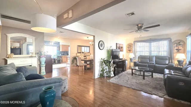 a living room with furniture and wooden floors