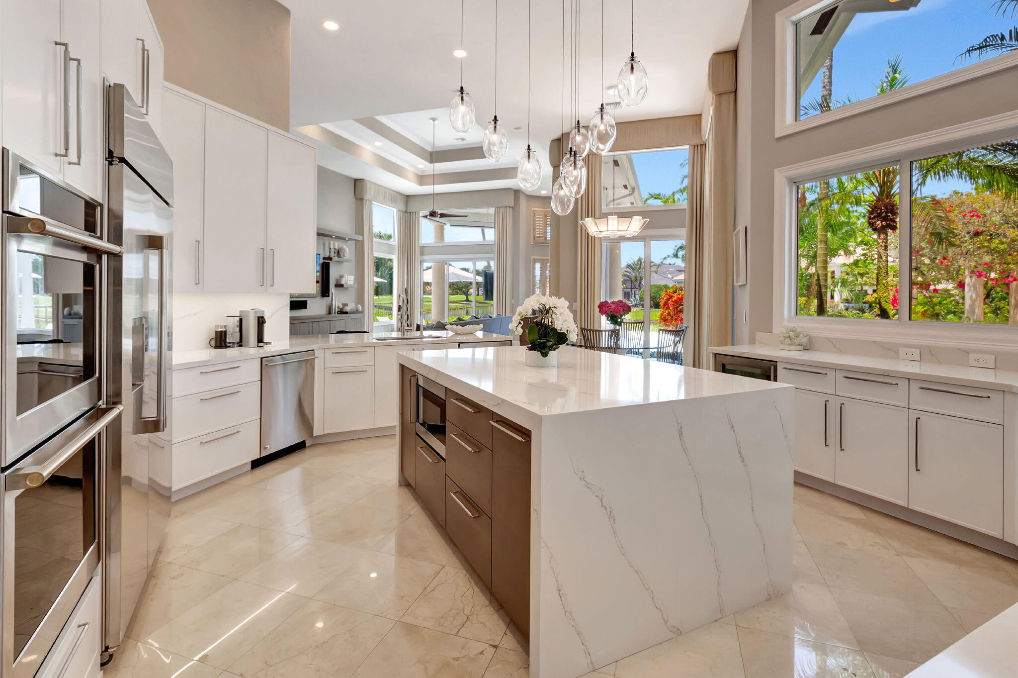 2599 Northwest 63rd Lane Boca Raton, FL 33496 - Photo 14 of 81 a kitchen with stainless steel appliances a sink a stove a refrigerator and white cabinets with wooden floor