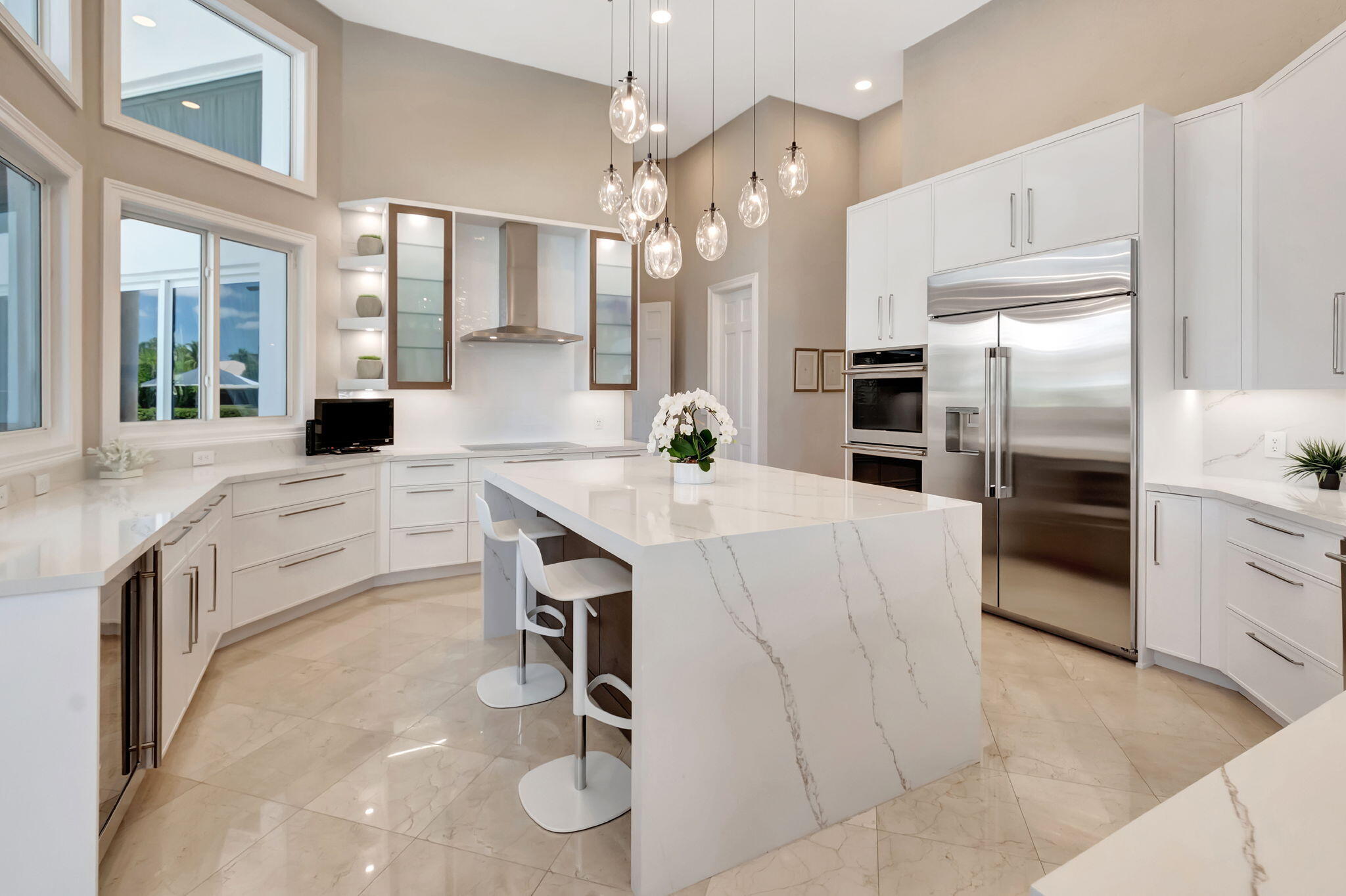 2599 Northwest 63rd Lane Boca Raton, FL 33496 - Photo 16 of 81 a kitchen with granite countertop a sink cabinets stainless steel appliances and a chandelier