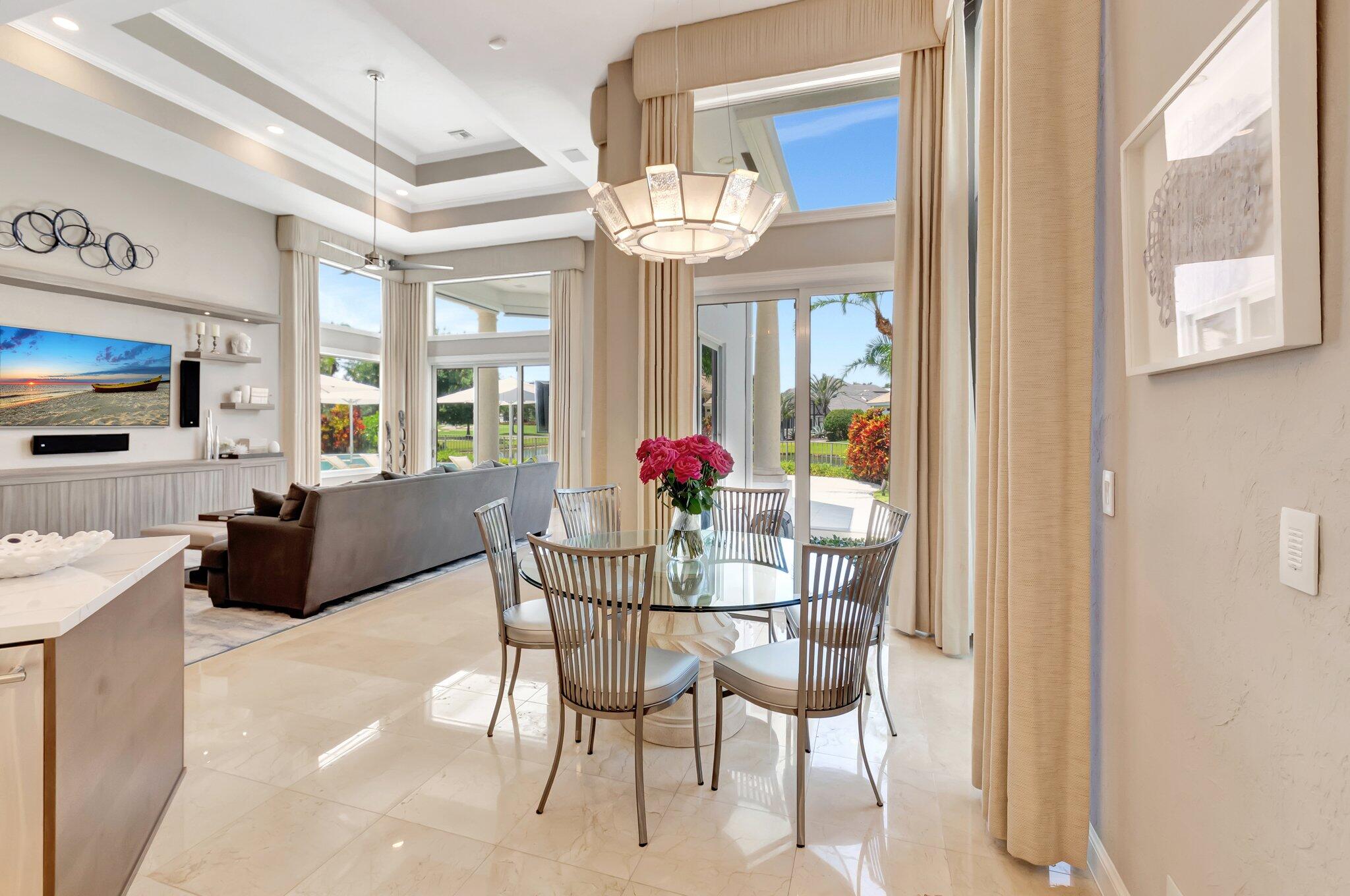 2599 Northwest 63rd Lane Boca Raton, FL 33496 - Photo 19 of 81 a view of a dining room with furniture a chandelier and large window