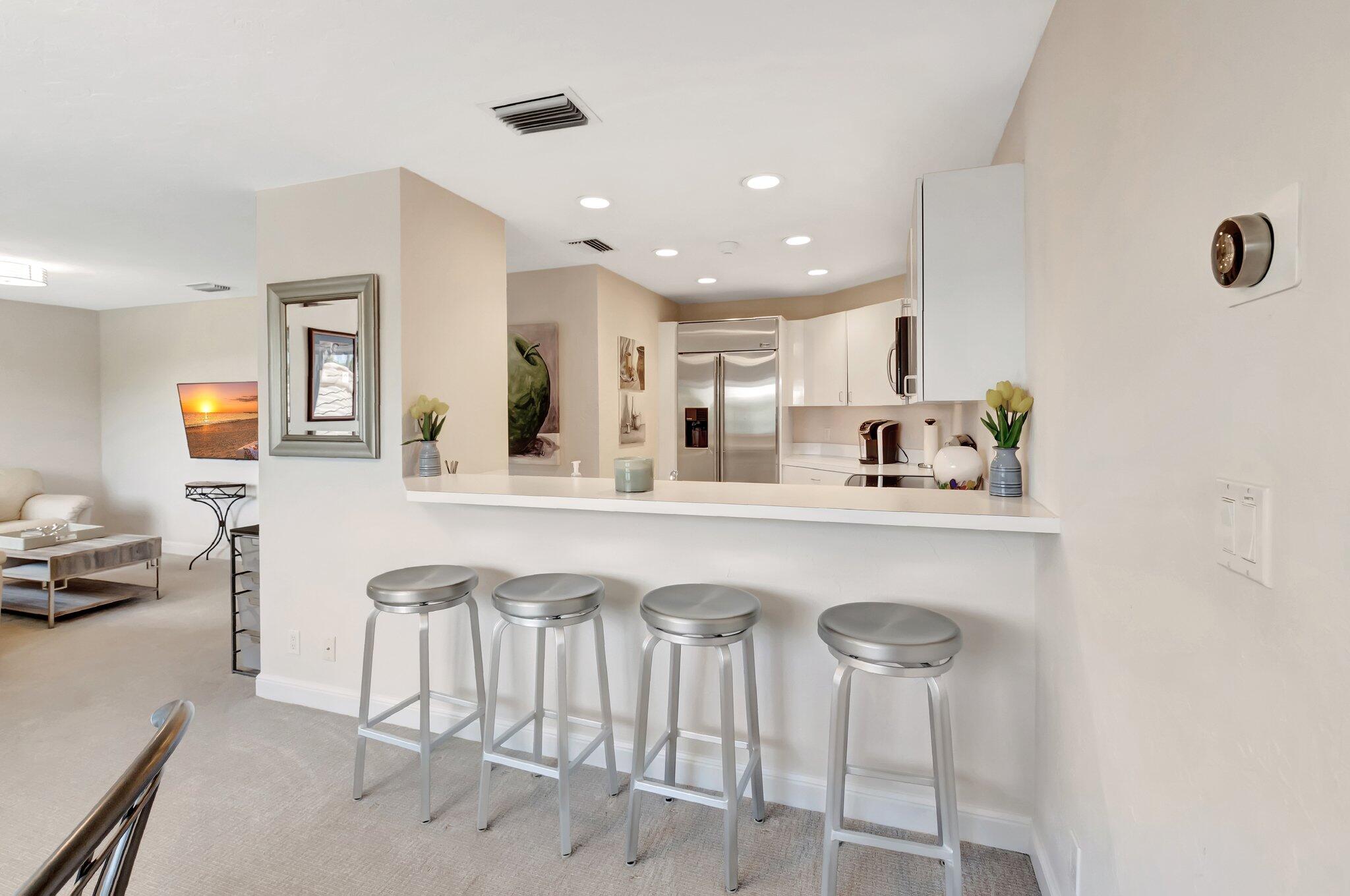 2599 Northwest 63rd Lane Boca Raton, FL 33496 - Photo 36 of 81 a kitchen with stainless steel appliances a table and chairs in it