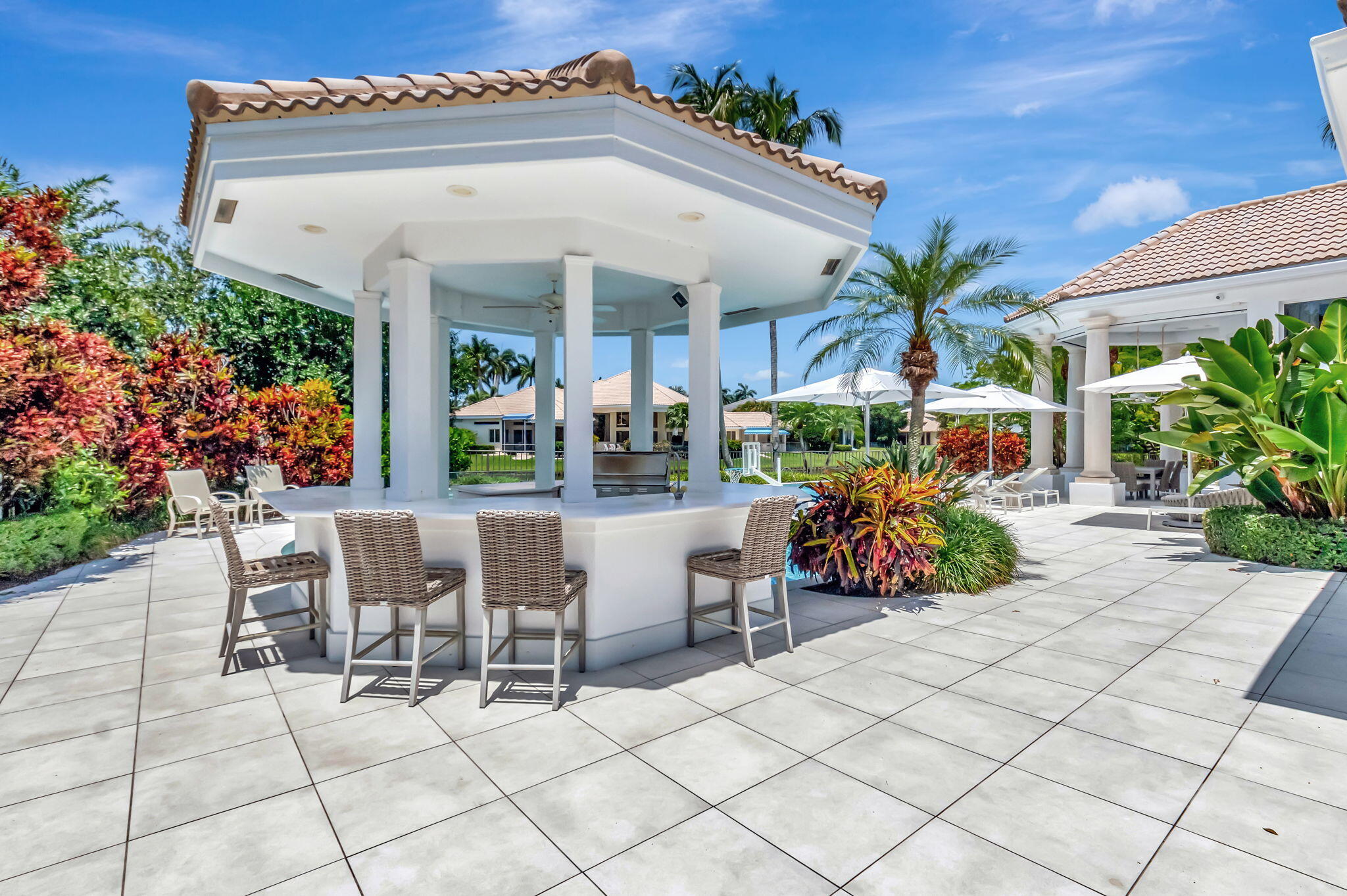 2599 Northwest 63rd Lane Boca Raton, FL 33496 - Photo 43 of 81 a view of a patio with table and chairs and potted plants