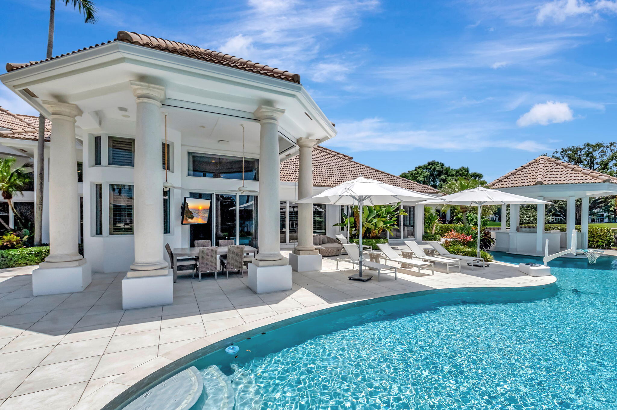 2599 Northwest 63rd Lane Boca Raton, FL 33496 - Photo 45 of 81 a view of a patio with a table and chairs under an umbrella