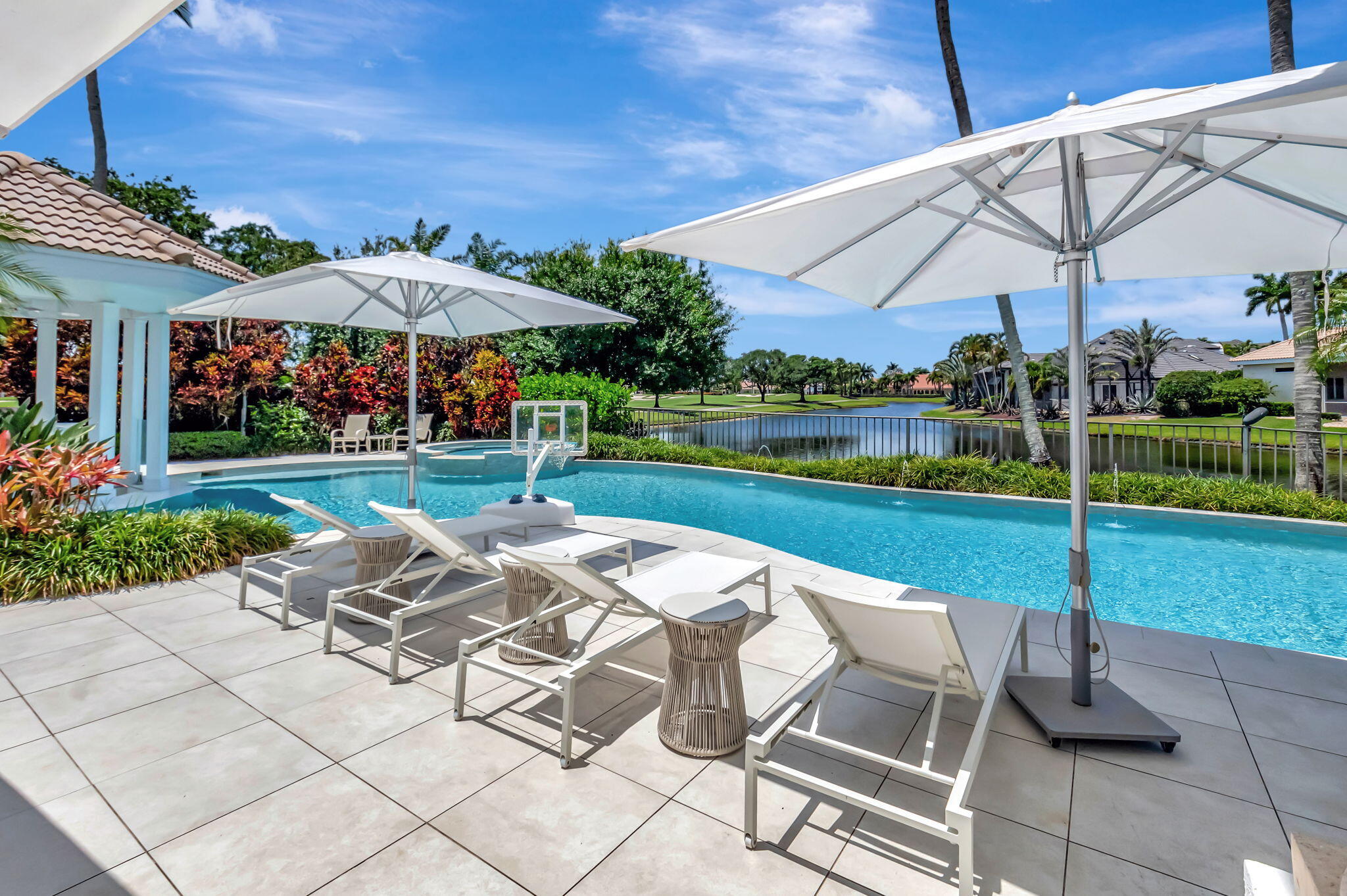 2599 Northwest 63rd Lane Boca Raton, FL 33496 - Photo 46 of 81 a view of a patio with a table and chairs under an umbrella