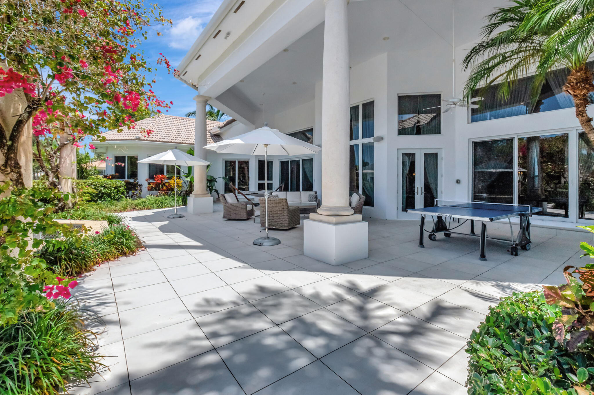 2599 Northwest 63rd Lane Boca Raton, FL 33496 - Photo 55 of 81 a view of a patio with table and chairs potted plants and large tree