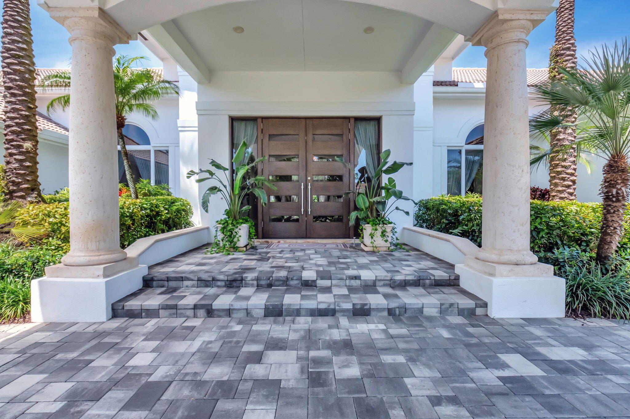 2599 Northwest 63rd Lane Boca Raton, FL 33496 - Photo 6 of 81 a view of a house with potted plants and a garage