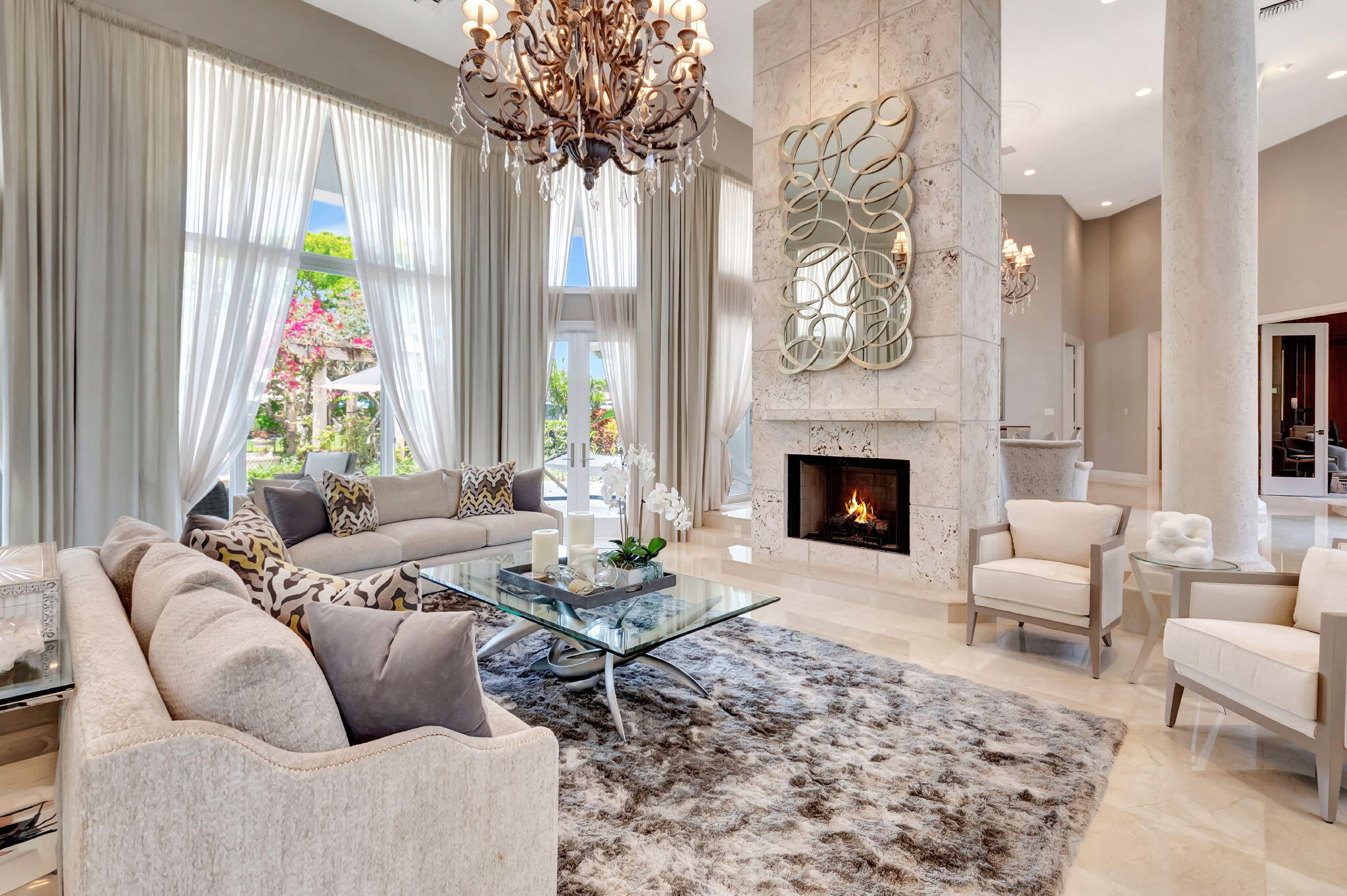 2599 Northwest 63rd Lane Boca Raton, FL 33496 - Photo 8 of 81 a living room with furniture a chandelier and a fireplace
