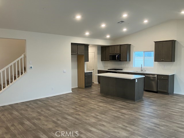 1340 Callista Way Perris, CA 92571 - Photo 2 of 3 a large kitchen with stainless steel appliances granite countertop a stove a sink and a microwave