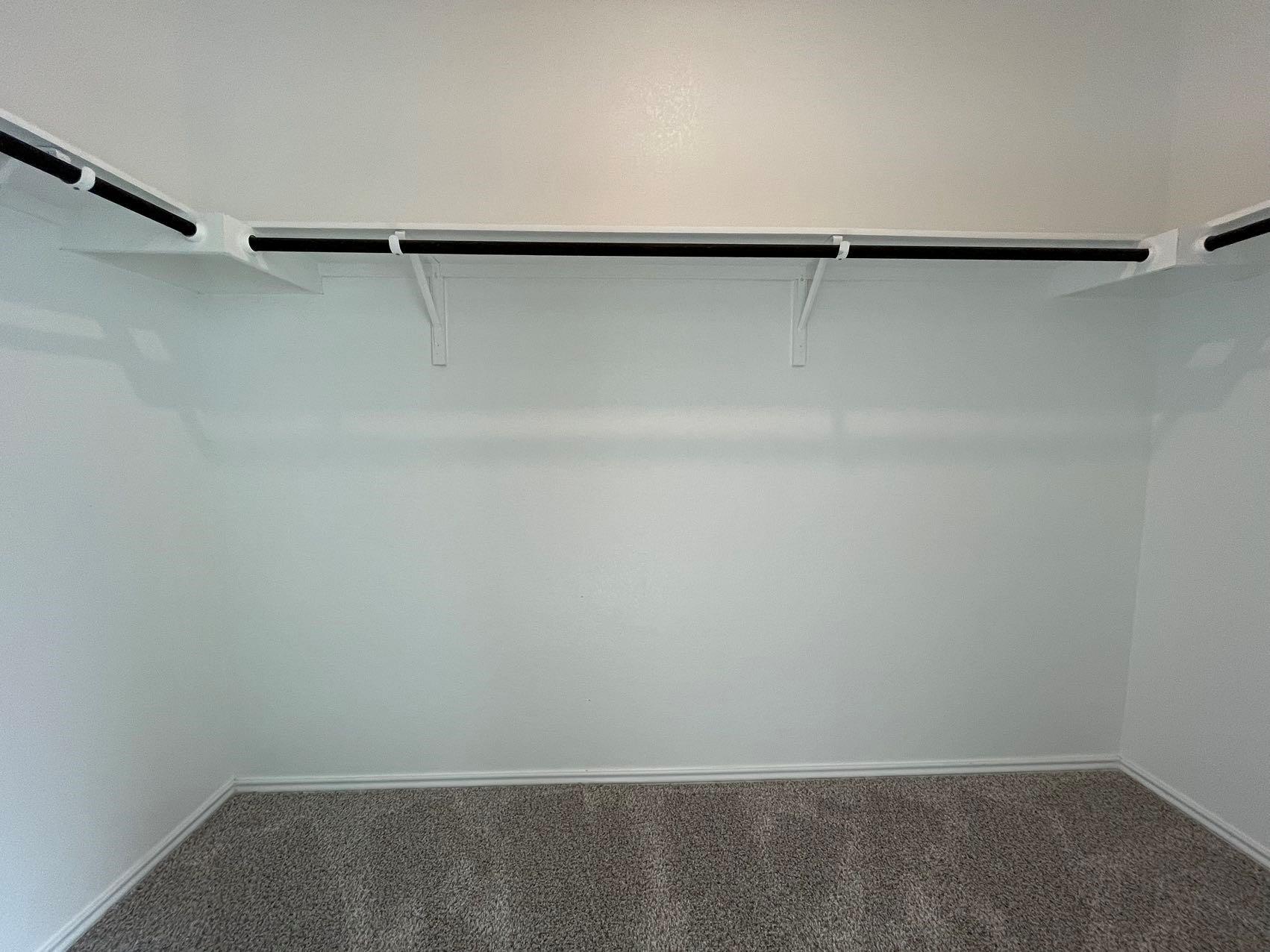 1625 Woolsey Way Leander, TX 78641 - Photo 14 of 17 Closet with white walls, baseboards, and grey carpeting, featuring shelving and hanging rods