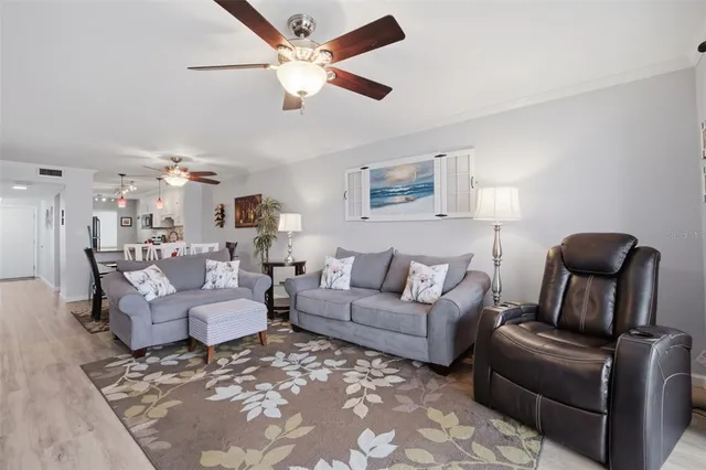 a living room with furniture and a ceiling fan